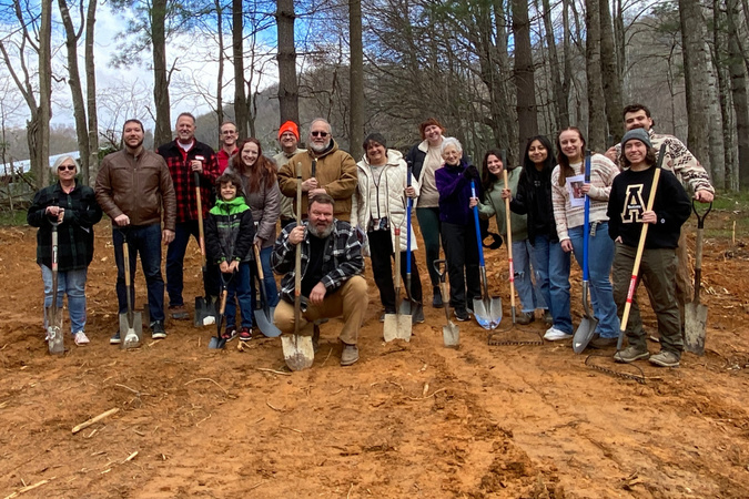 App Builds a Home students and volunteers posing with shovels outside.