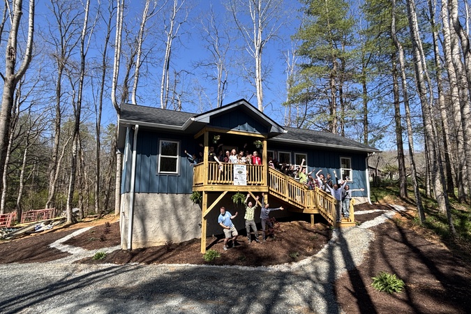 Finished Lee family home with family and ABAH volunteers out front. 